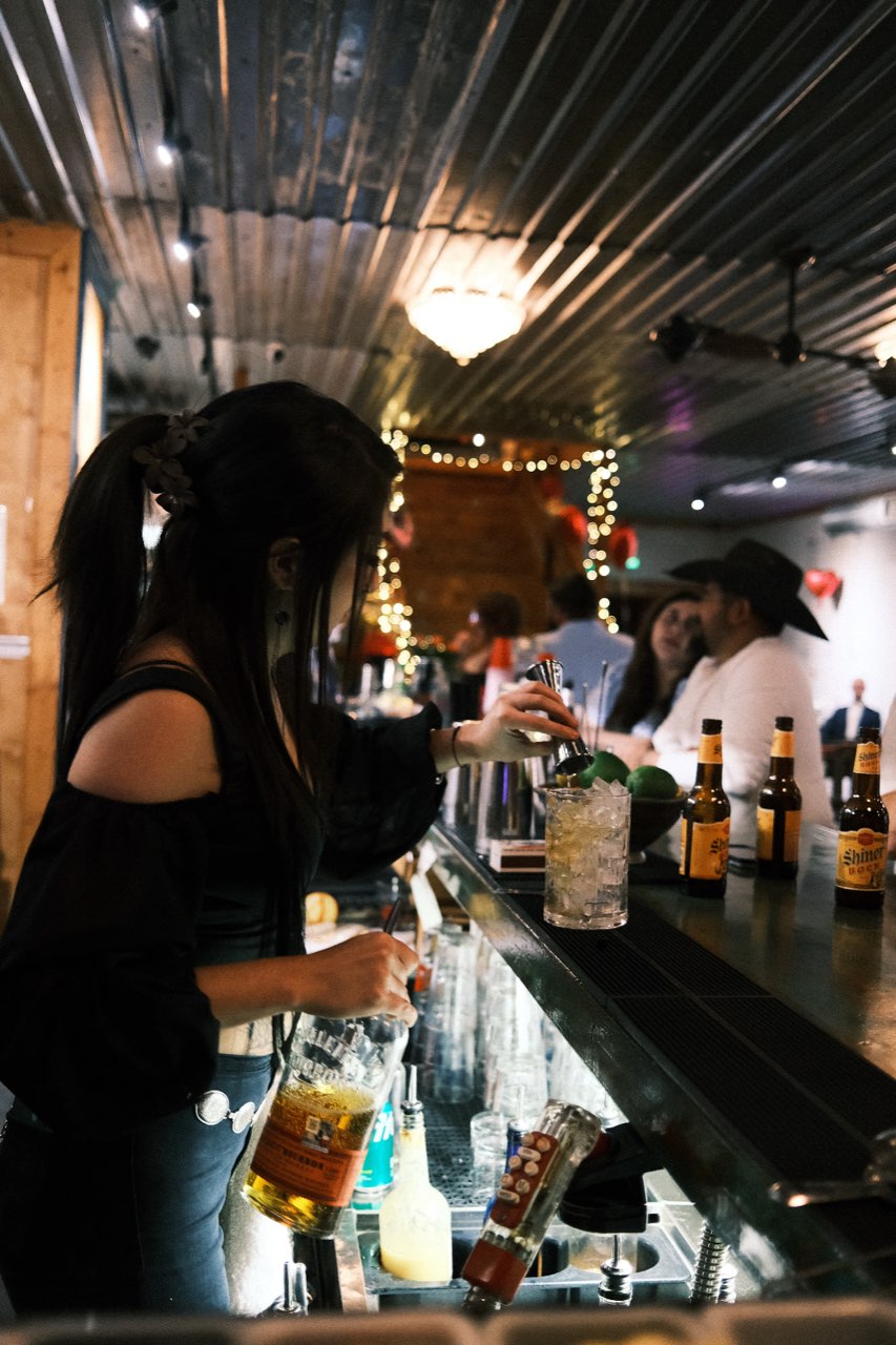 Bartender preparing craft cocktails at an Alcove Social catered event